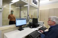 FILE PHOTO: Workers test an N95 mask at a laboratory of 3M in Maplewood, Minnesota