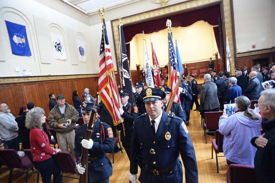 The Brockton Fire Department and Brockton Police Department Honor Guards present the colors during a Memorial Day ceremony at the War Memorial Building, on Memorial Day, Monday, May 31, 2021.