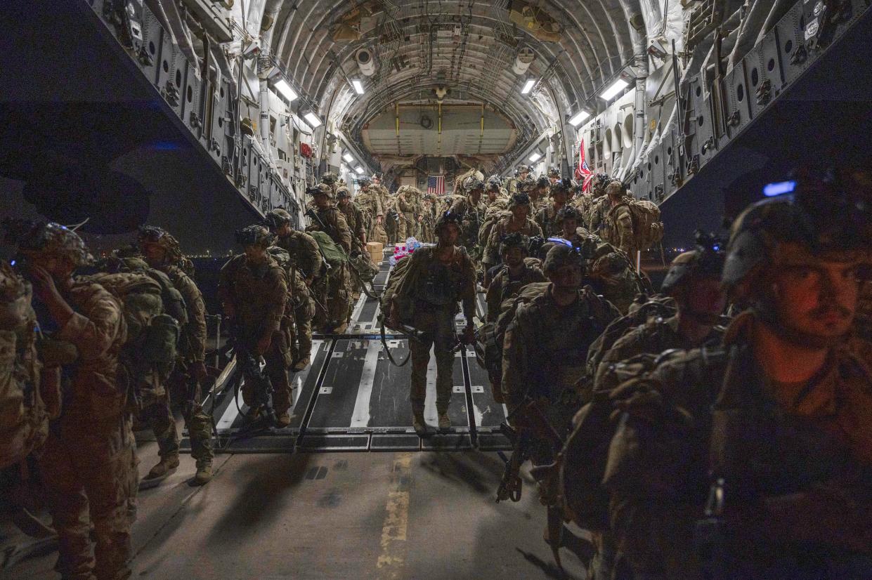 In this Aug. 31, 2021, photo provided by the U.S. Air Force, soldiers, assigned to the 82nd Airborne Division, deplane a U.S. Air Force C-17 Globemaster III aircraft after touching down at Ali Al Saleem Air Base, Kuwait. 