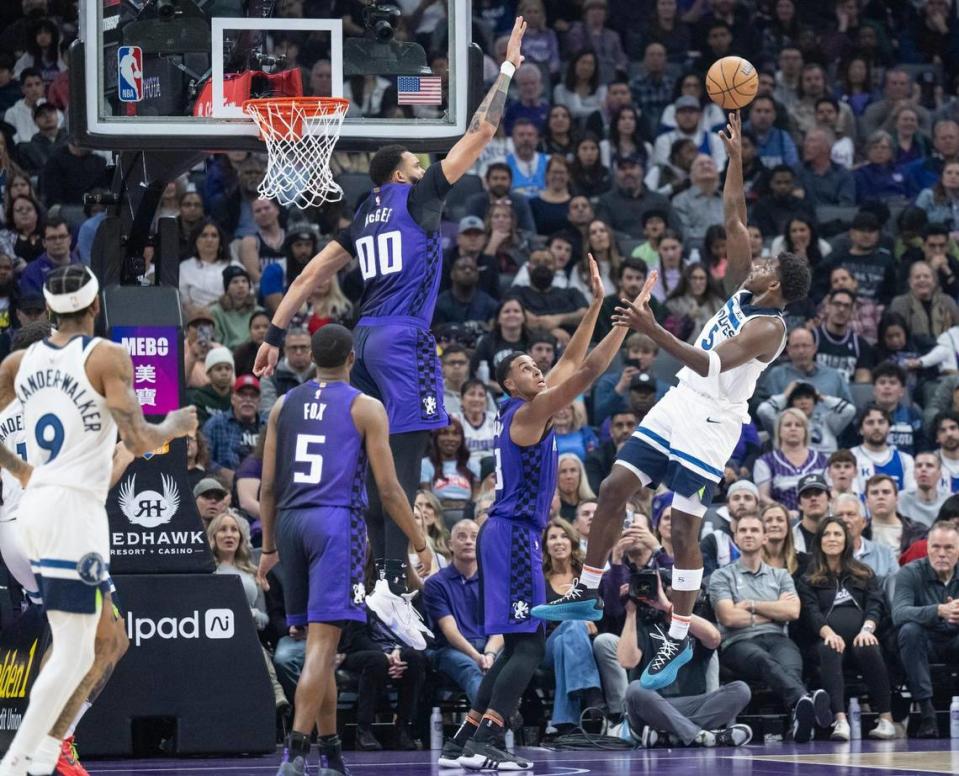 Minnesota Timberwolves guard Anthony Edwards (5) shoots over Sacramento Kings forward Keegan Murray (13) and center JaVale McGee (00) in the first half of the NBA basketball game on Saturday, Dec. 23, 2023, at Golden 1 Center.