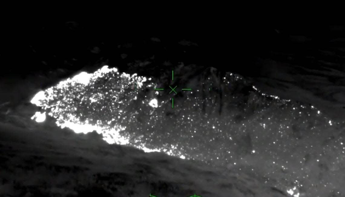 In this infrared aerial image from video looking southeast across the Washburn Fire in Yosemite National Park late Thursday night, July 14, 2022, light areas show the most active fire areas on the east side of the wildfire in the neighboring Sierra National Forest and along the Merced River’s south fork, at lower left. Scattered points of fire are visible to the upper right along the ridgeline of Raymond Mountain.