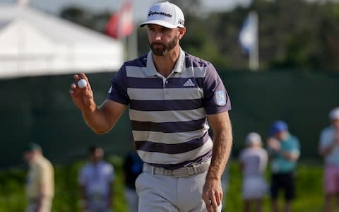 Dustin Johnson reacts after putting on the 10th green during the third round of the U.S. Open Golf Championship - Credit: AP