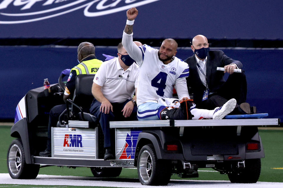 ARLINGTON, TEXAS - OCTOBER 11:  Dak Prescott #4 of the Dallas Cowboys is carted off the field after sustaining a leg injury against the New York Giants during the third quarter at AT&T Stadium on October 11, 2020 in Arlington, Texas. (Photo by Tom Pennington/Getty Images)