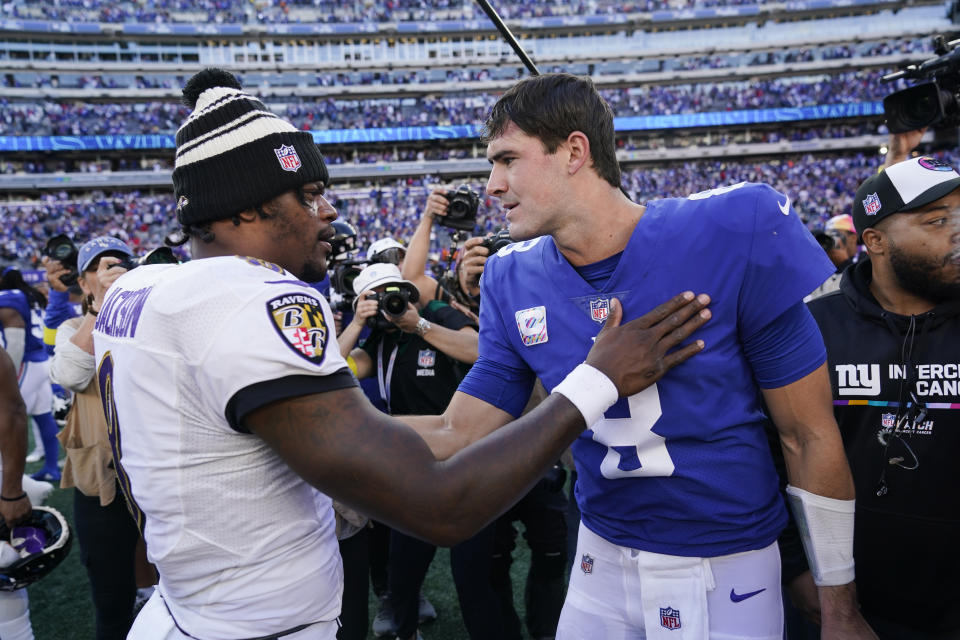 Baltimore Ravens quarterback Lamar Jackson, left, talks to New York Giants quarterback Daniel Jones after an NFL football game, Sunday, Oct. 16, 2022, in East Rutherford, N.J. The Giants won 24-20. (AP Photo/Seth Wenig)