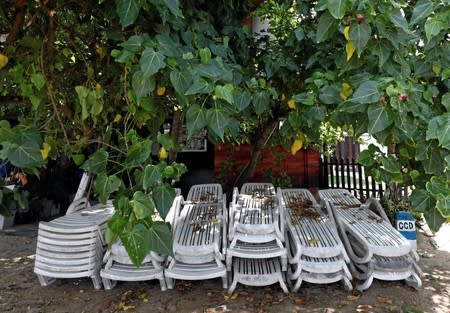 Sunbathing chairs are seen near a hotel at Unawatuna beach in Galle