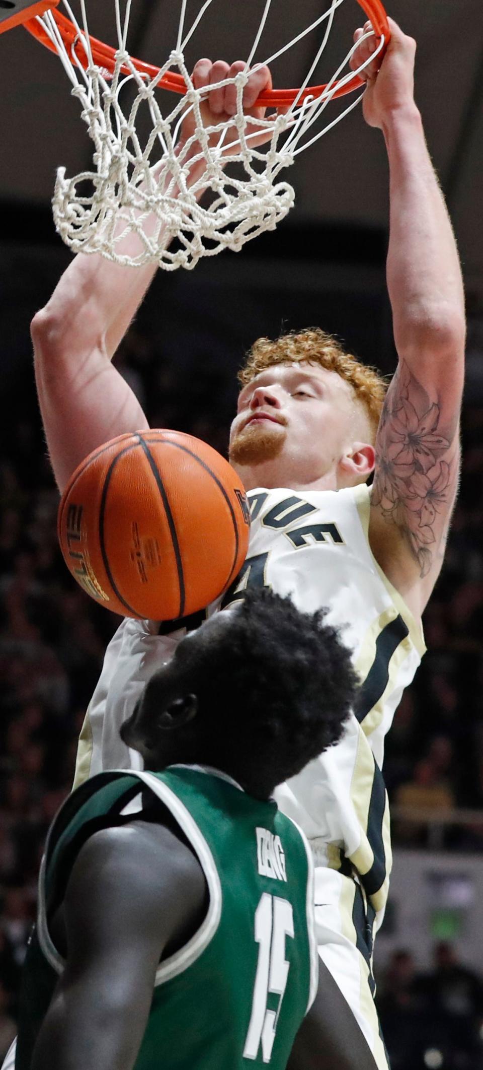 Purdue Boilermakers center Will Berg (44) dunks the ball over Jacksonville Dolphins forward Tito Deng (15) during the NCAA men’s basketball game, Thursday, Dec. 21, 2023, at Mackey Arena in West Lafayette, Ind. Purdue Boilermakers won 100-57.