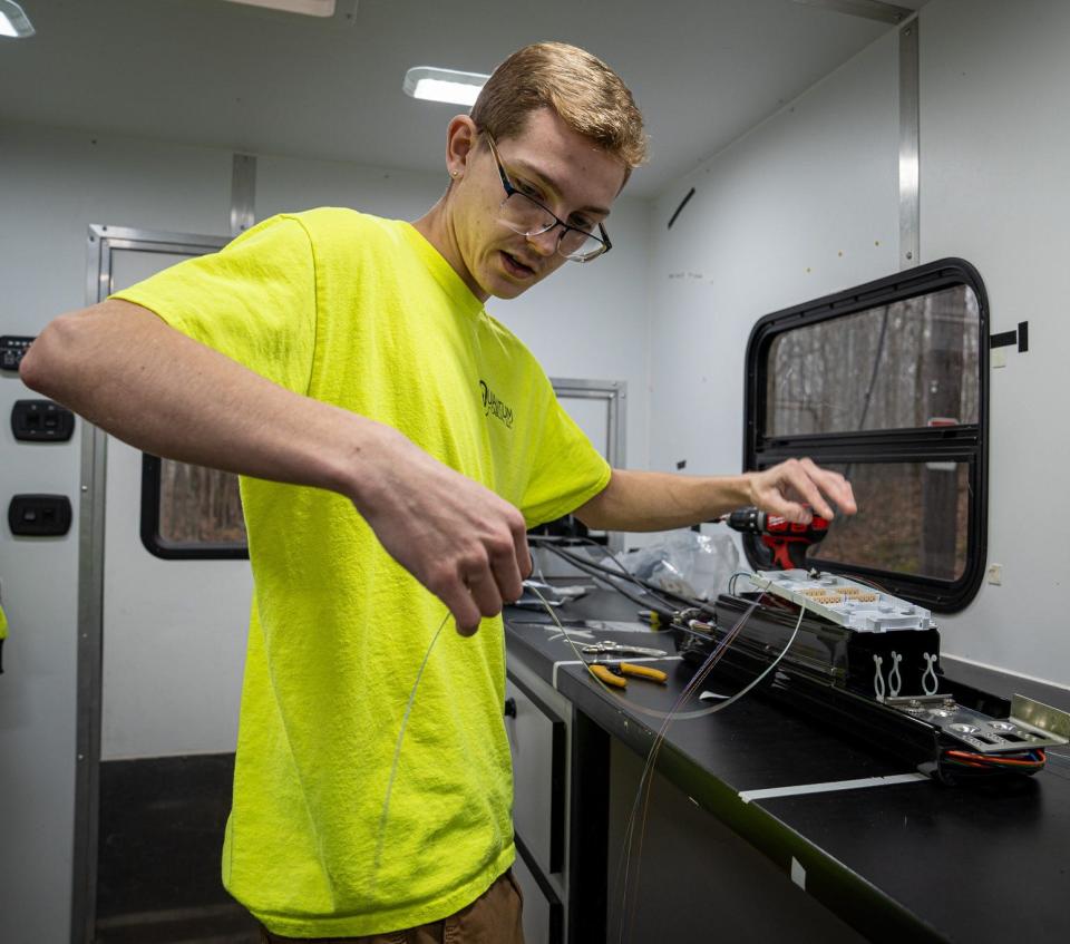 Fiber technician Dylan Jodarski prepares to splice fiber for the fiber optic cable that's bringing high-speed internet service to Washington Island. The project is a joint effort by Sturgeon Bay-based Quantum Technologies and the Washington Island Electric Cooperative.