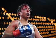 Mexico's Erika Cruz Hernandez, left, heads to hear corner after the fourth round of a women's featherweight championship boxing bout against Puerto Rico's Amanda Serrano Saturday, Feb. 4, 2023 in New York. Serrano won the fight. (AP Photo/Frank Franklin II)