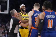 Referee Scott Foster, left, separates Indiana Pacers' Isaiah Jackson (22) and New York Knicks' Isaiah Hartenstein (55) during the first half of Game 5 in an NBA basketball second-round playoff series, Tuesday, May 14, 2024, in New York. (AP Photo/Frank Franklin II)