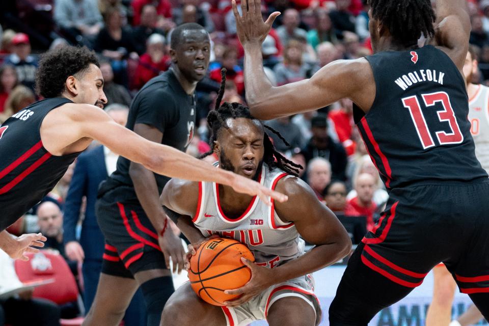 Jan 3, 2024; Columbus, OH, USA;
Ohio State Buckeyes guard Bruce Thornton (2) maintains possession of the ball against Rutgers Scarlet Knights guard Noah Fernandes (2) and forward Antwone Woolfolk (13) during their game on Wednesday, Jan. 3, 2024 at Value City Arena.