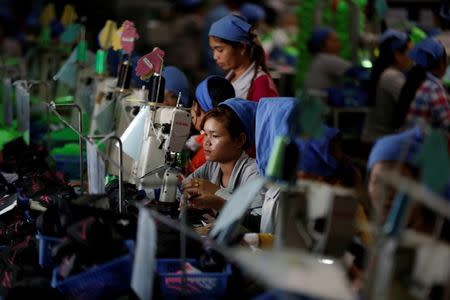 Women work on the production line at Complete Honour Footwear Industrial, a footwear factory owned by a Taiwan company, in Kampong Speu, Cambodia, July 4, 2018. REUTERS/Ann Wang SEARCH "CAMBODIA FACTORY" FOR THIS STORY. SEARCH "WIDER IMAGE" FOR ALL STORIES.