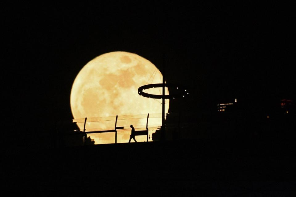 The super blue moon rises behind Marina Bay Sands observation deck in Singapore on Aug. 31, 2023. <span class="copyright">Roslan Rahman—AFP/Getty Images</span>