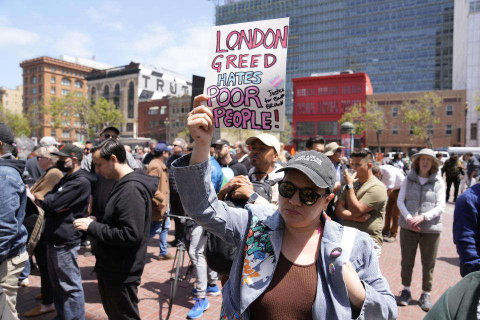 An activist holds up a sign during a rare outdoor meeting of the Board of Supervisors at UN Plaza in San Francisco, Tuesday, May 23, 2023. Mayor London Breed attempted to answer questions from supervisors demanding her administration do more to shut down open-air drug dealing, but the meeting had to be moved indoors to City Hall because of disruptions. (AP Photo/Eric Risberg)