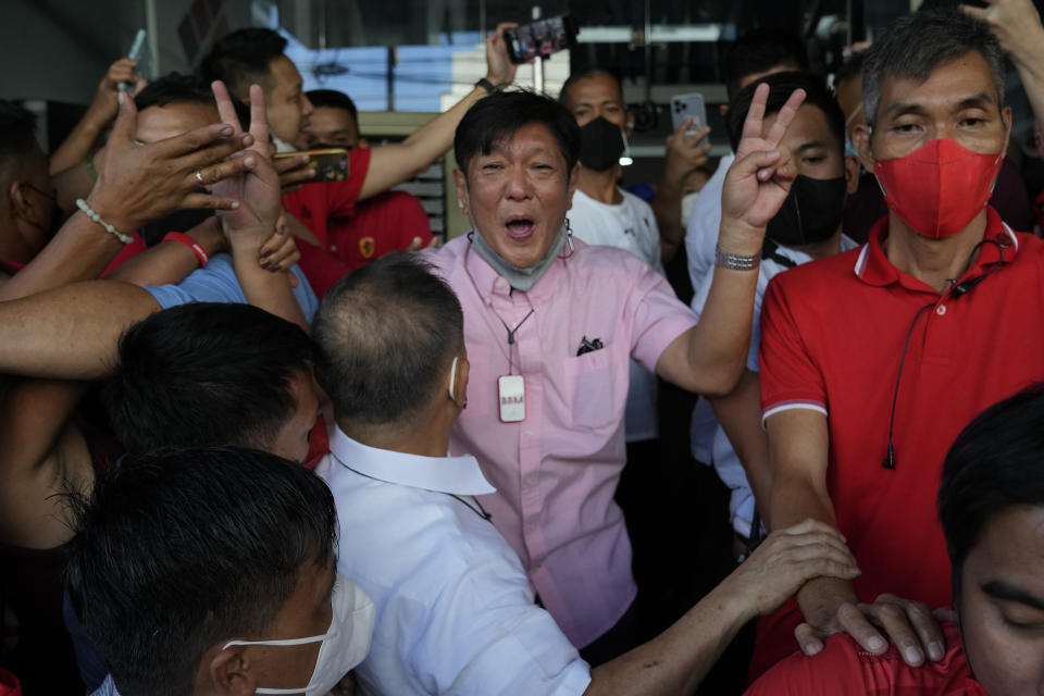 Presidential candidate Ferdinand "Bongbong" Marcos Jr. celebrates outside his headquarters in Mandaluyong, Philippines on Wednesday, May 11, 2022. Marcos' apparent landslide victory in the Philippine presidential election is raising immediate concerns about a further erosion of democracy in Asia and could complicate American efforts to blunt growing Chinese influence and power in the Pacific. (AP Photo/Aaron Favila)