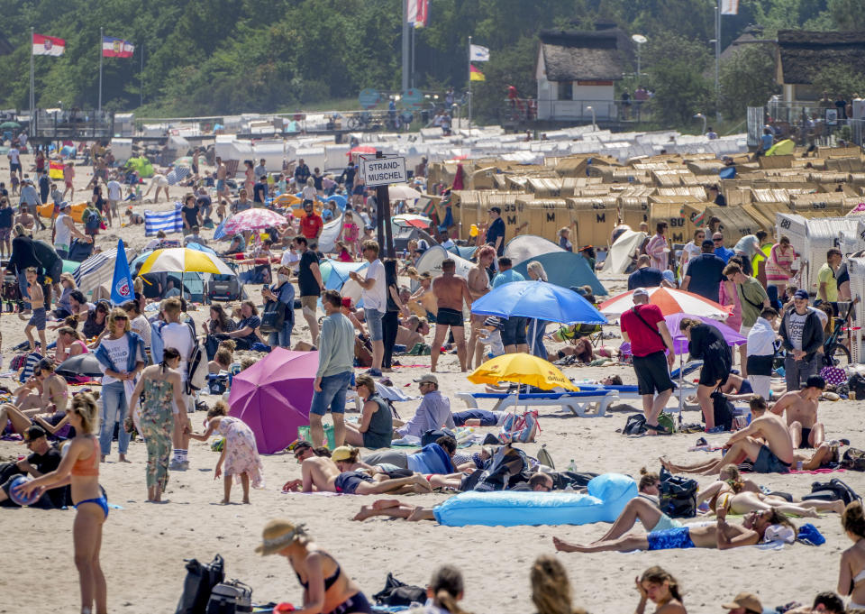 People spend the day at the beach of the Baltic Sea in Scharbeutz, northern Germany, on a sunny Saturday, June 5, 2021. It was the first run to the beaches after some Corona restrictions in that region ended. (AP Photo/Michael Probst)
