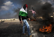 <p>Masked Palestinians clash with Israeli troops as they mark the “Land Day” in the east Jerusalem neighborhood of Issawiyeh on March 30, 2012. (Photo: Oded Balilty/AP) </p>