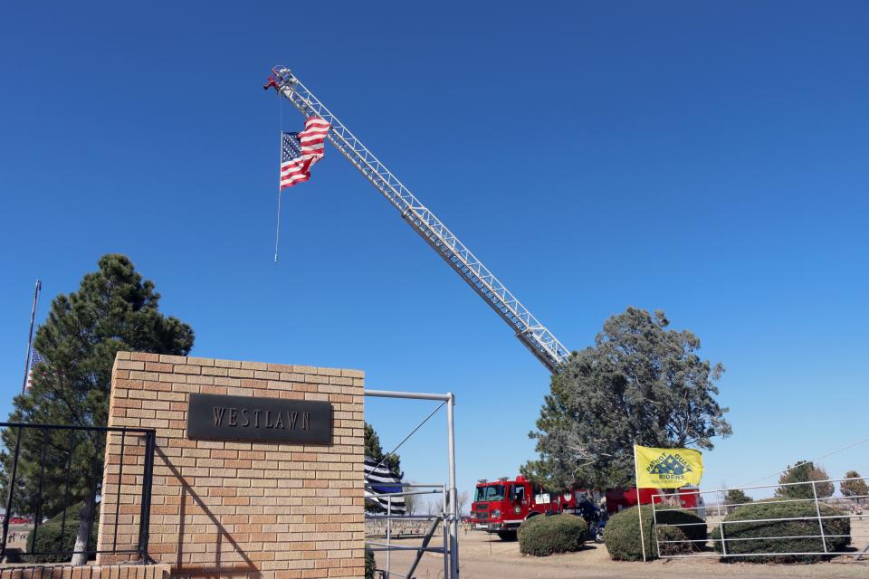 An American flag flies from the back of a firetruck during the memorial service for Fritch Fire Chief Zeb Smith on Saturday.