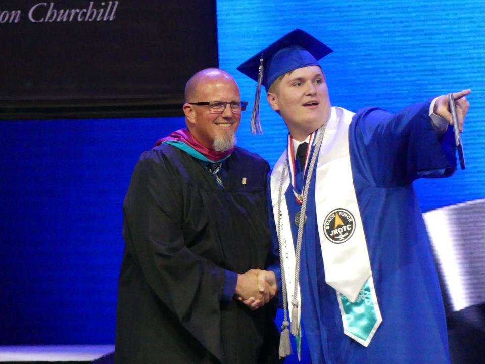 Principal Chet Richards congratulates a senior during the Academy for Academic Excellence annual commencement ceremony on Friday, June 9, 2023 at High Desert Church in Victorville.