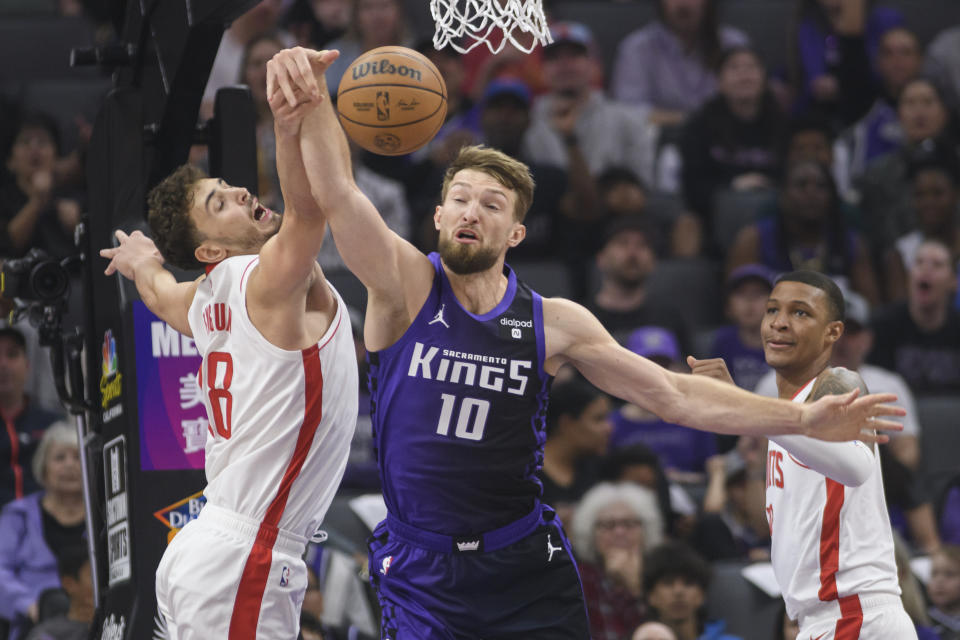 Houston Rockets center Alperen Sengun, left, and Sacramento Kings forward Domantas Sabonis (10) battle for a rebound during the first half of an NBA basketball game in Sacramento, Calif., Sunday, March 10, 2024. (AP Photo/Randall Benton)