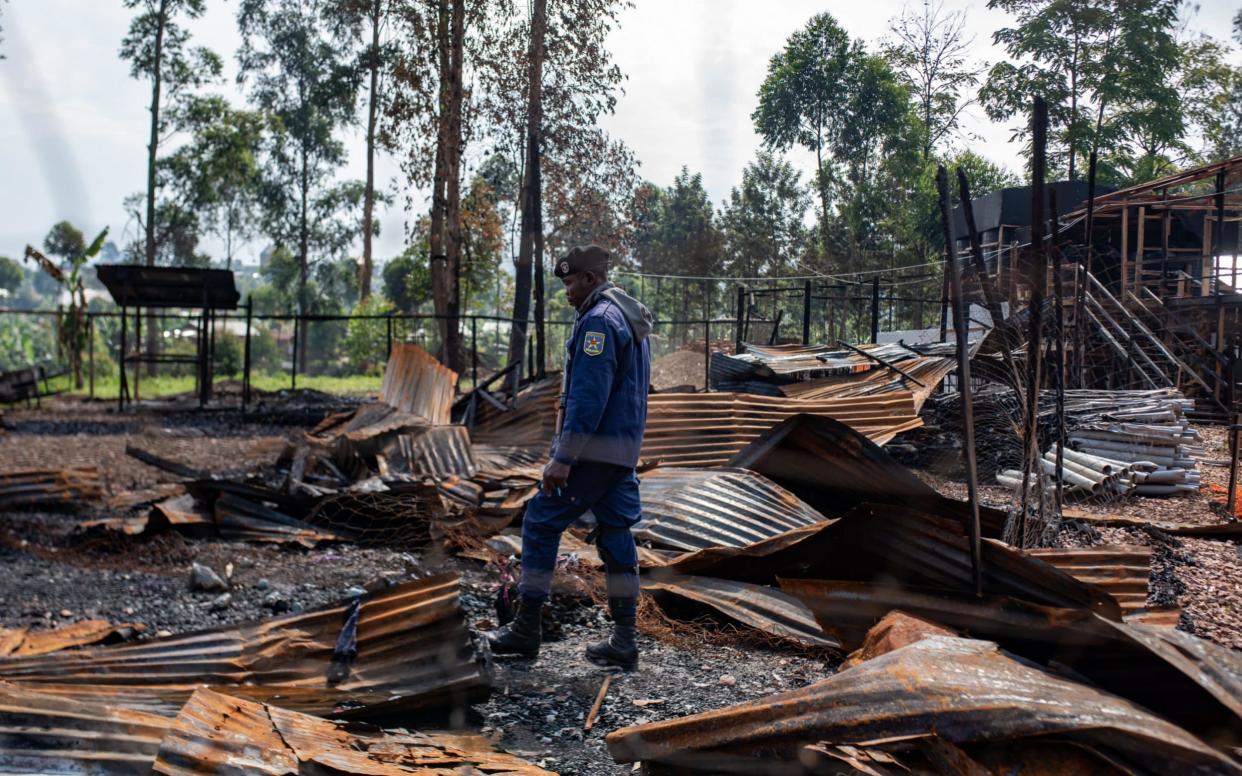 Nurses crept past smoldering heaps of rubble to rescue patients after the clinic was set on fire - Olivia Acland/Telegraph