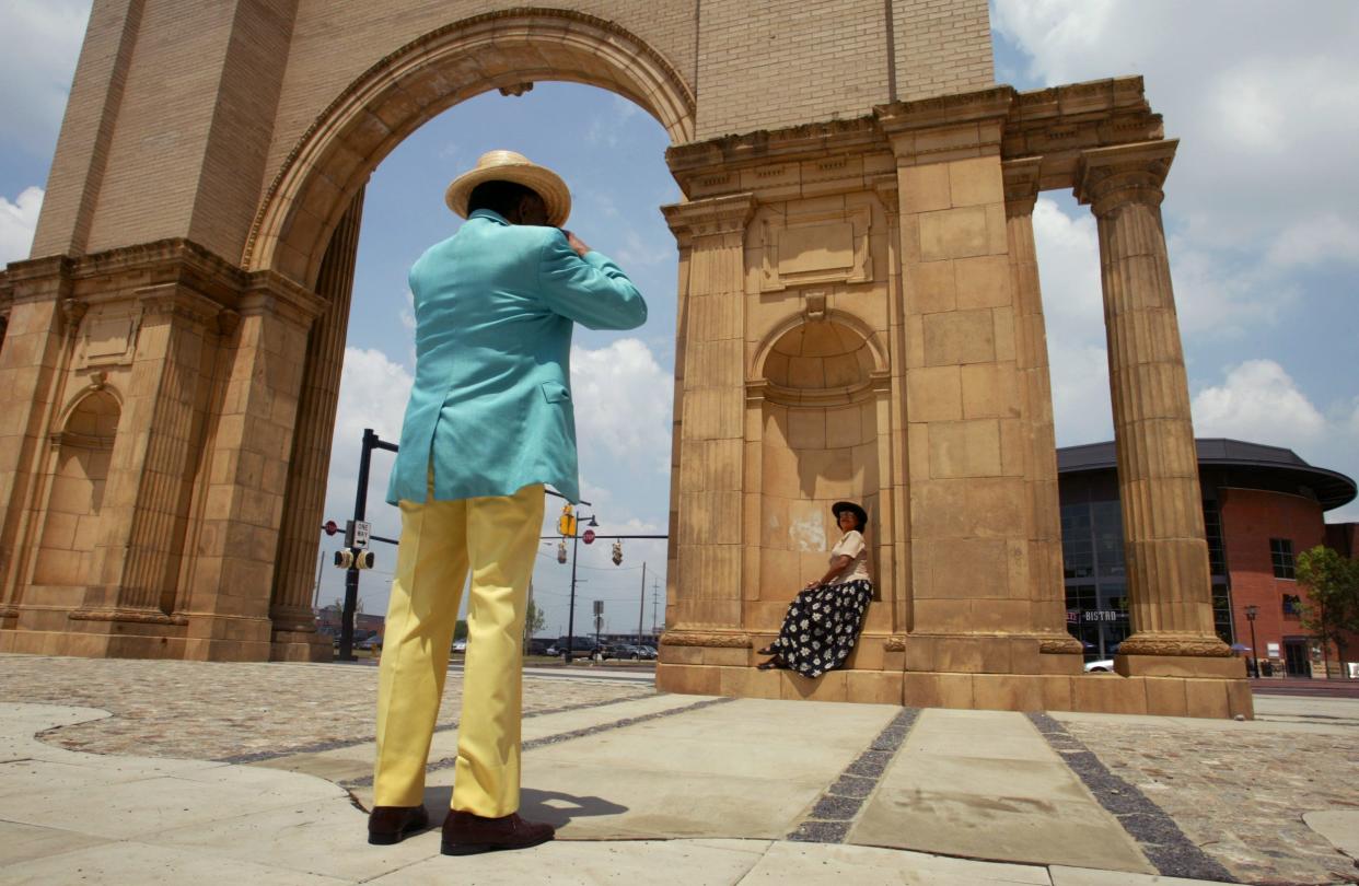 2002 - Donald Mebane of Washington D.C. takes a picture of Senetta Almira of Columbus next to the Union Station Arch.