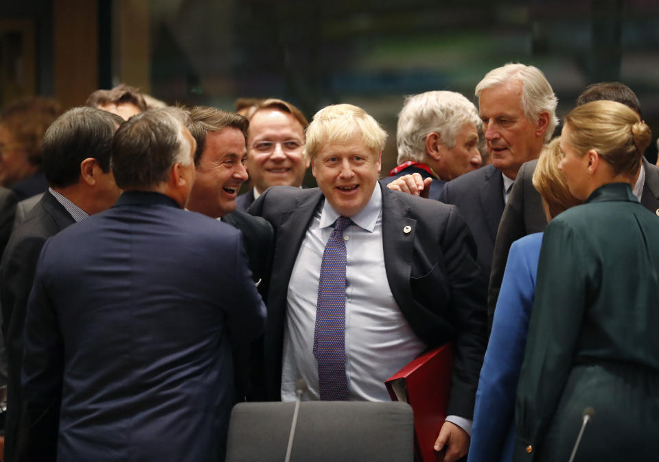 FILE - British Prime Minister Boris Johnson, center, is greeted by Luxembourg's Prime Minister Xavier Bettel, center left, during a round table meeting at an EU summit in Brussels Thursday, Oct. 17, 2019. British media say Prime Minister Boris Johnson has agreed to resign on Thursday, July 7 2022, ending an unprecedented political crisis over his future. (AP Photo/Frank Augstein, File)