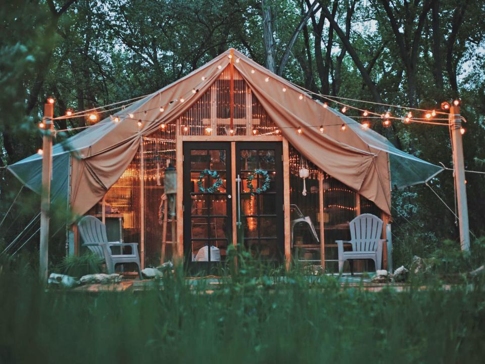 The exterior of Zac Ruiz's tiny house tent with string lights