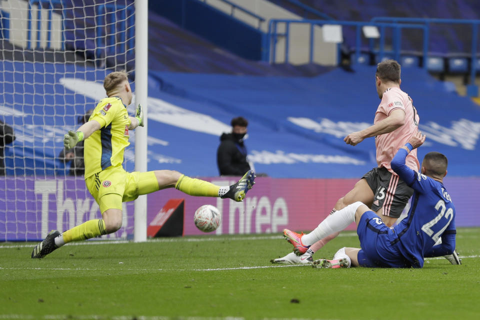 Chelsea's Hakim Ziyech, right, scores his side's second goal during the English FA Cup quarterfinal soccer match between Chelsea and Sheffield United at the Stamford Bridge stadium in London, Sunday, March 21, 2021. (AP Photo/Kirsty Wigglesworth)