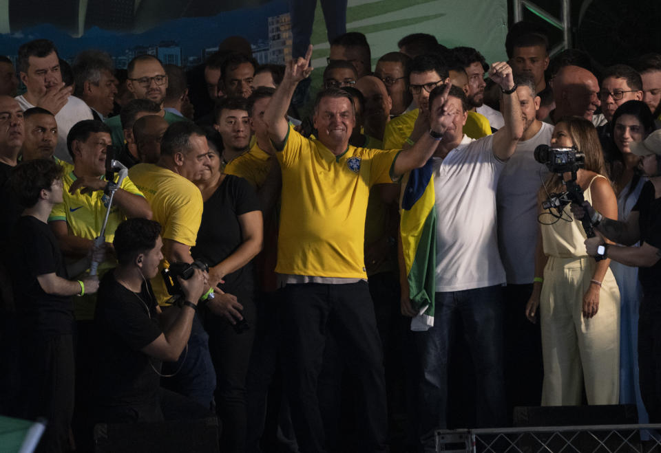 Brazil's former President Jair Bolsonaro greets supporters during a campaign event launching the pre-candidacy of a mayoral candidate, in Rio de Janeiro, Brazil, Saturday, March 16, 2024. (AP Photo/Silvia Izquierdo)