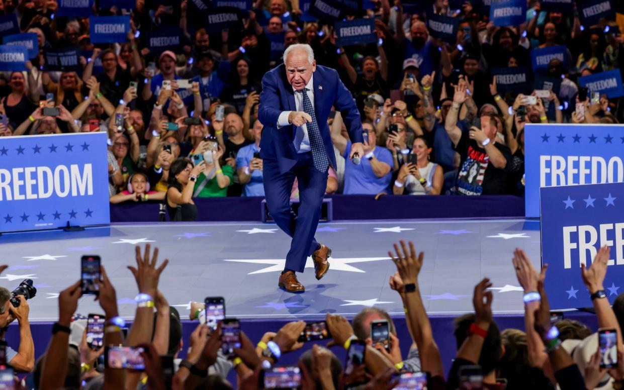 Minnesota Governor Tim Walz gestures during a campaign rally at Fiserv Arena in Milwaukee, Wisconsin