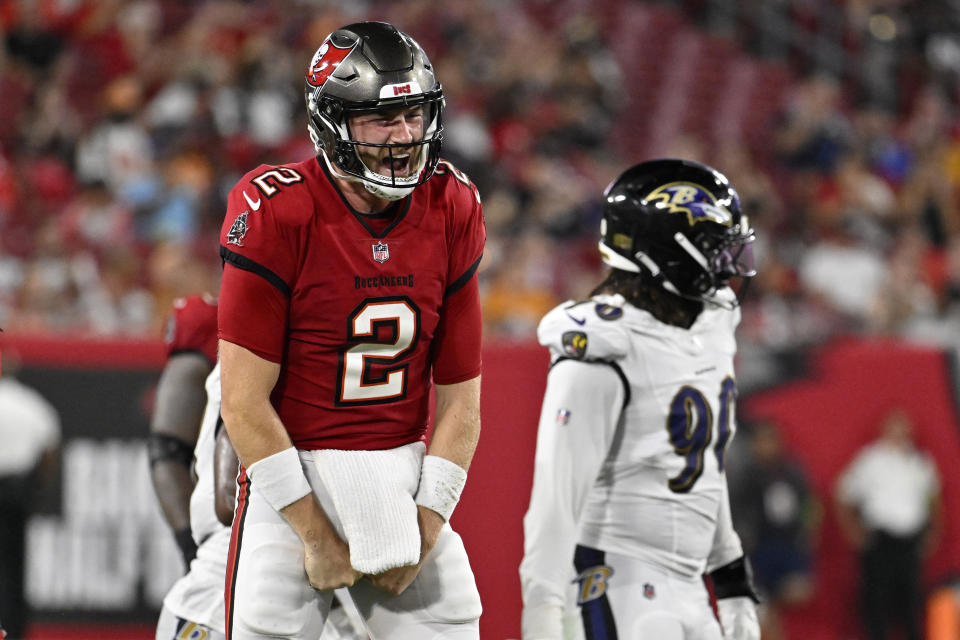 Tampa Bay Buccaneers quarterback Kyle Trask celebrates after running the ball for a first down during the second half of an NFL preseason football game against the Baltimore Ravens Saturday, Aug. 26, 2023, in Tampa, Fla. (AP Photo/Jason Behnken)