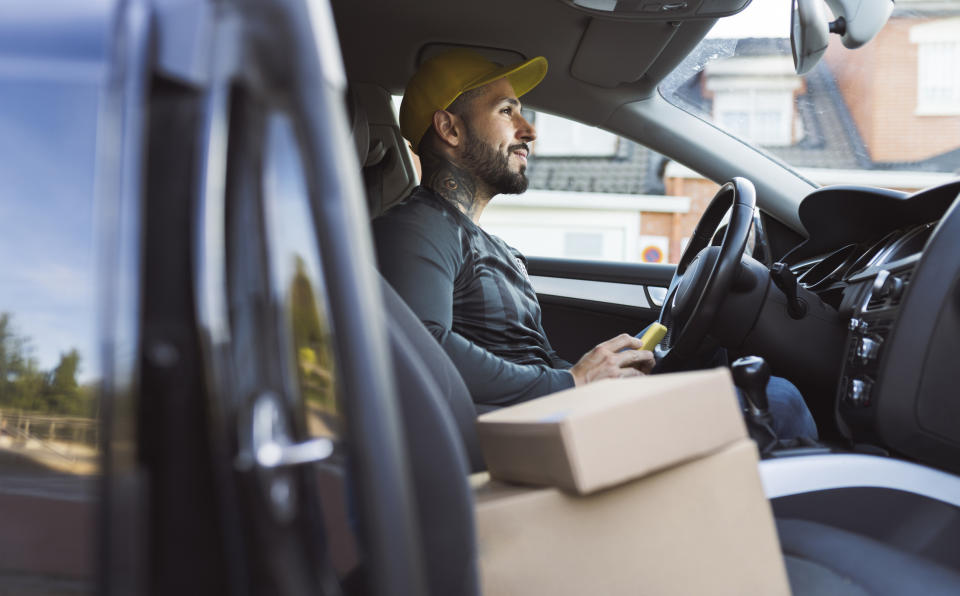 A man driving with packages