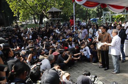 Indonesian presidential candidate Joko "Jokowi" Widodo speaks after casting his vote at a polling station in Jakarta July 9, 2014. REUTERS/Darren Whiteside