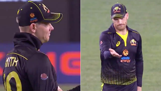 Steve Smith and Aaron Finch talk as they find out Pat Cummins was on a hat-trick.