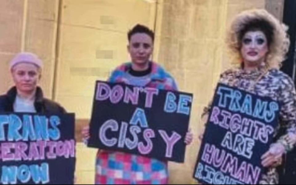 The trio had their picture taken outside JK Rowling's home while holding placards