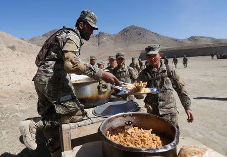 New recruits to the Afghan army Special Forces have their lunch after take part in a military demonstration in Rishkhur district outside Kabul, Afghanistan February 25, 2017. Picture taken on February 25, 2017. REUTERS/Omar Sobhani