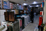 Employees wait for customers at a almost empty complex selling home furniture for government employees in Baghdad, Iraq, Tuesday, Oct. 20, 2020. Iraq is in the throes of an unprecedented liquidity crisis, as the cash-strapped state wrestles to pay public sector salaries and import essential goods while oil prices remain dangerously low. (AP Photo/Khalid Mohammed)