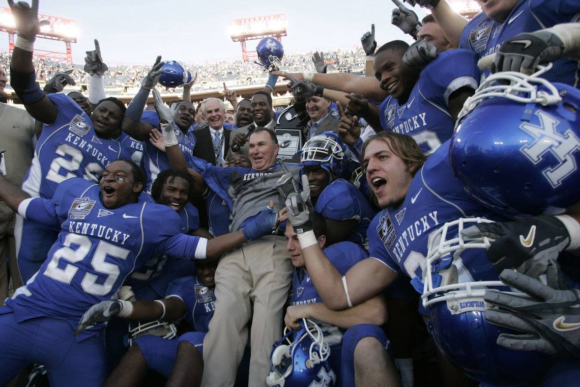 UK head coach Rich Brooks jumped into a pile of his players after they were presented their trophy after beating Clemson 28-20 in the Music City Bowl at LP Field in Nashville on Dec. 29, 2006.