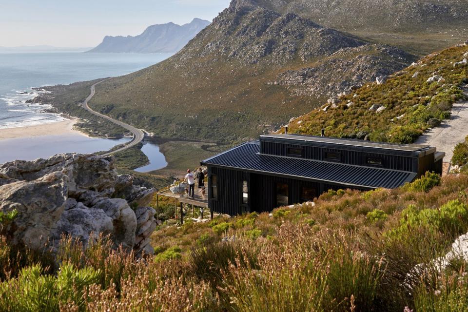 In the midst of the pandemic, a family leverages industry connections and modular construction to quickly rebuild a cliffside getaway on a fire-ravaged site in the Kogelberg Biosphere Reserve.