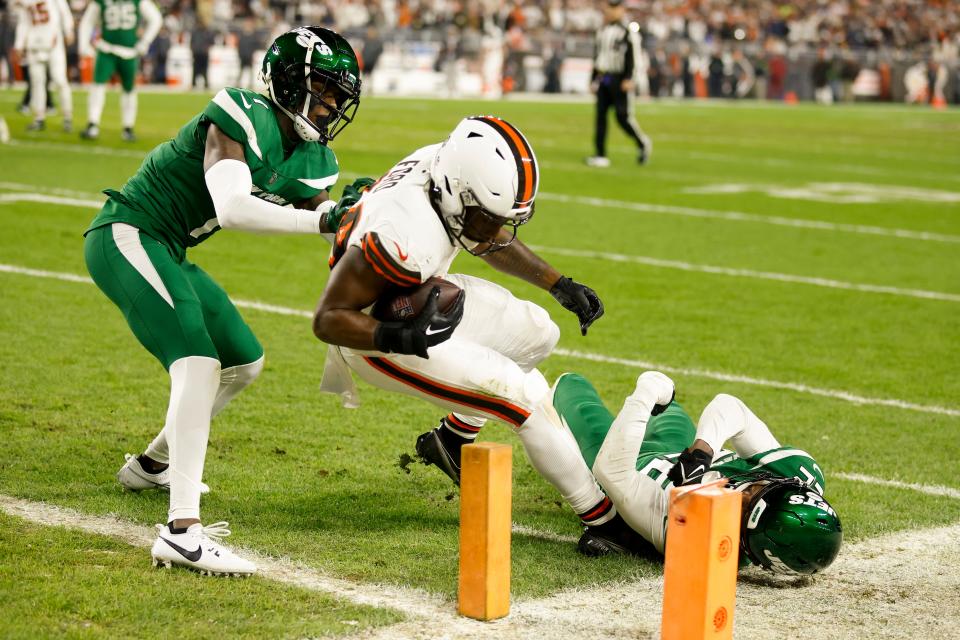 Cleveland Browns running back Jerome Ford scores between New York Jets cornerback Sauce Gardner, left, and safety Tony Adams on Dec. 28, 2023, in Cleveland.