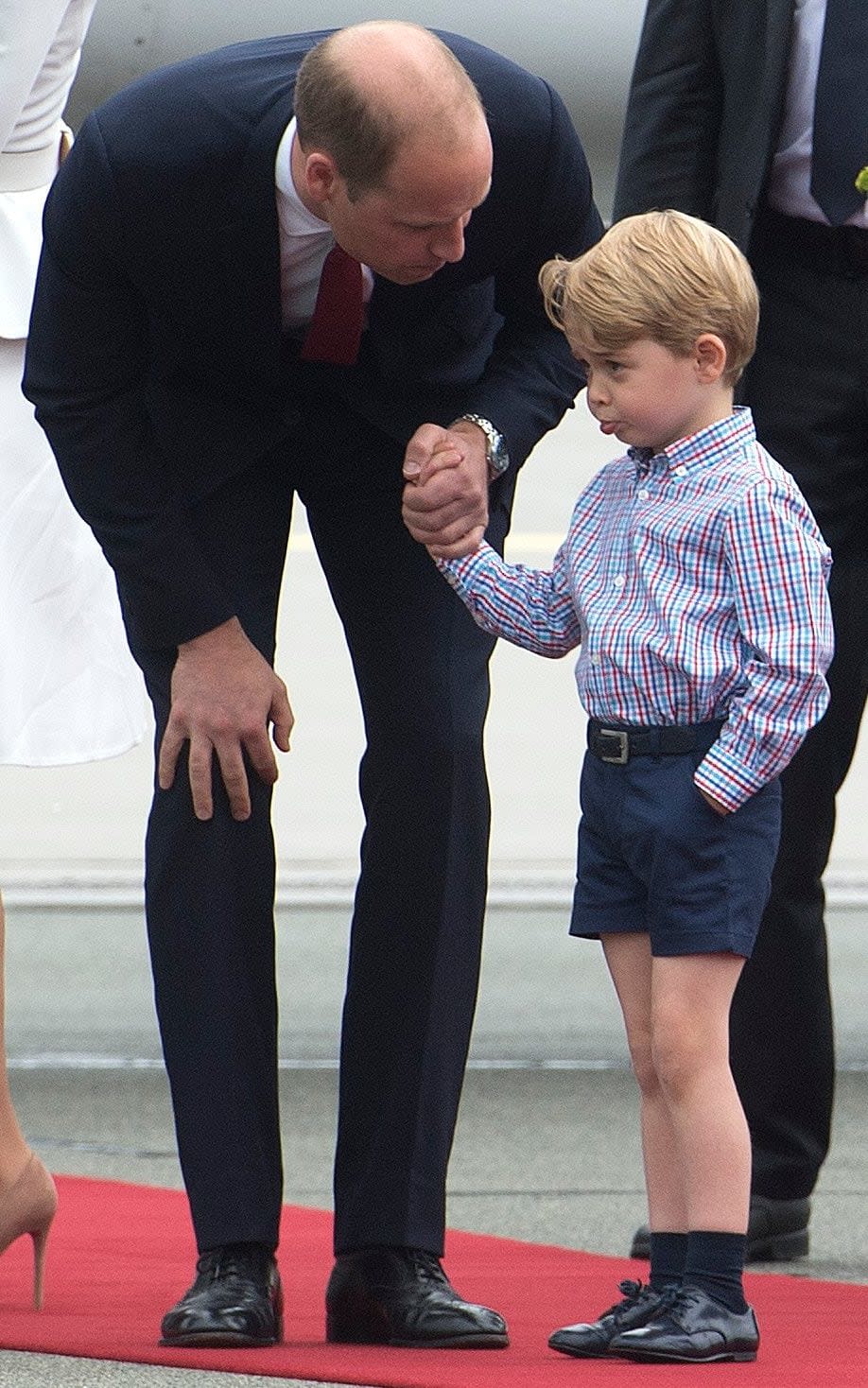 The Duke of Cambridge has a word with a shy Prince George after the family landed in Warsaw - Credit: JULIAN SIMMONDS for The Telegraph