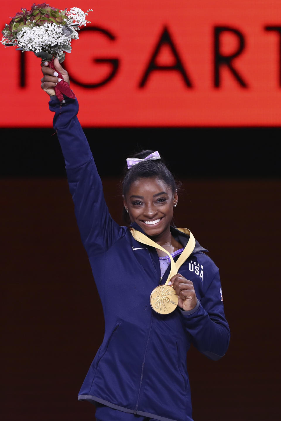 Gold medalist Simone Biles of the United States celebrates during the award ceremony for the balance beam in the women's apparatus finals at the Gymnastics World Championships in Stuttgart, Germany, Sunday, Oct. 13, 2019. (AP Photo/Matthias Schrader)