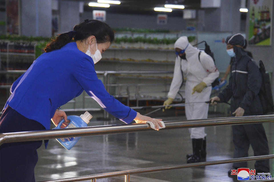 FILE - In this photo published on June 28, 2022 by the North Korean government, North Korean employees disinfect a facility at an underground store in Pyongyang, North Korea. Independent journalists were not given access to cover the event depicted in this image distributed by the North Korean government. The content of this image is as provided and cannot be independently verified. Korean language watermark on image as provided by source reads: "KCNA" which is the abbreviation for Korean Central News Agency. North Korea on Thursday, Aug. 25, 2022, said it found four new fever cases in its border region with China that may have been caused by coronavirus infections, two weeks after leader Kim Jong Un declared a widely disputed victory over COVID-19. (Korean Central News Agency/Korea News Service via AP, File)