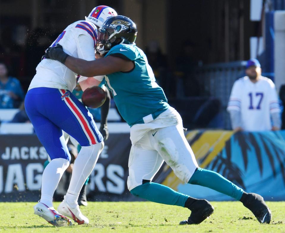 Defensive end Dawuane Smoot (91) hits Buffalo Bills quarterback Josh Allen in 2021.