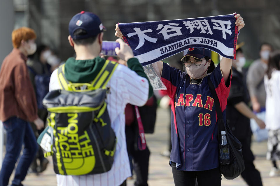 A fan of Japan's Shohei Ohtani holds up a banner which reads "Shohei Ohtani" prior to the Pool B game between Japan and China at the World Baseball Classic (WBC) at the Tokyo Dome Thursday, March 9, 2023, in Tokyo. Japanese baseball player Shohei Ohtani is arguably the game's best player. But he's more than just a baseball player. He's an antidote for many in his native country. (AP Photo/Eugene Hoshiko)