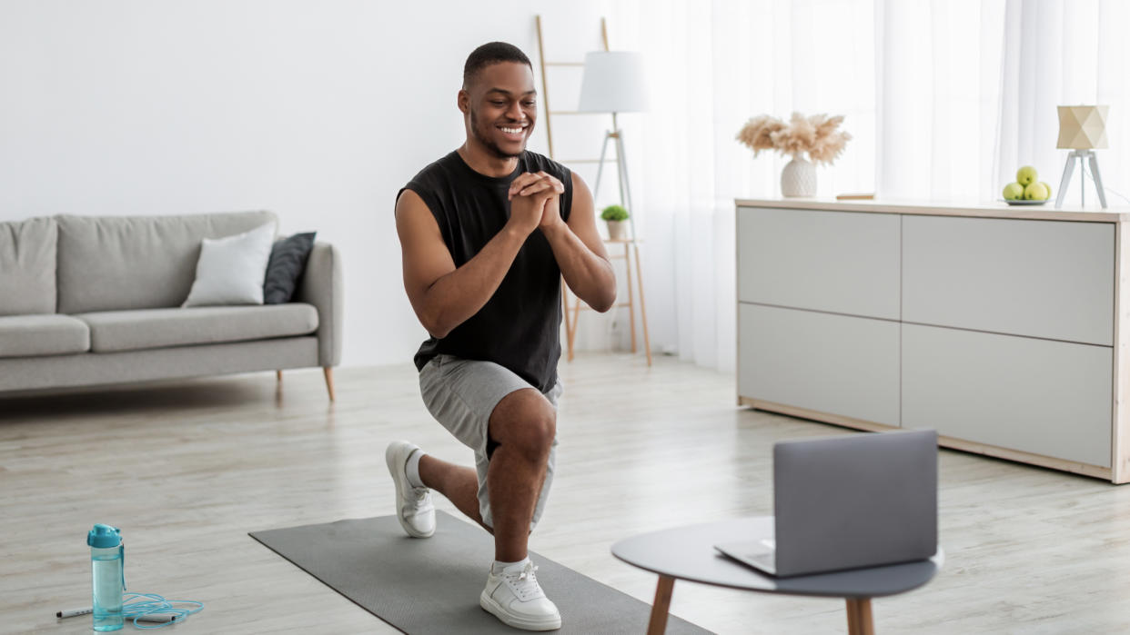  Man performing a lunge at home 