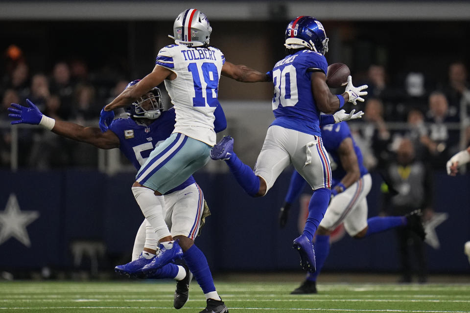 New York Giants cornerback Darnay Holmes (30) intercepts a pass intended for Dallas Cowboys wide receiver Jalen Tolbert (18) in the second half of an NFL football game, Sunday, Nov. 12, 2023, in Arlington, Texas. (AP Photo/Julio Cortez)