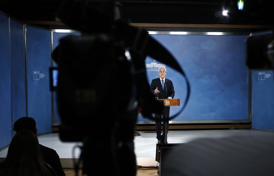 Chilean President Sebastián Piñera addresses the nation from La Moneda presidential palace, amid ongoing demonstrations triggered by an increase in subway fares in Santiago, Chile, Monday, Oct. 21, 2019. Protesters defied an emergency decree and confronted police in Chile’s capital Monday, continuing violent clashes, arson and looting that have left at least 11 dead and led the president to say the country is “at war.” (AP Photo/Luis Hidalgo)