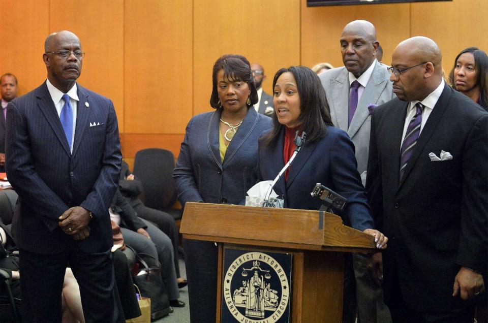 PHOTO: District Attorney Paul Howard, left, stands by the podium while prosecutor Fani Willis, center, speaks during a news conference following sentencing for 10 defendants convicted in the Atlanta Public Schools test-cheating trial, April 14, 2015. (Kent D. Johnson/Atlanta Journal-Constitution via AP, Pool)