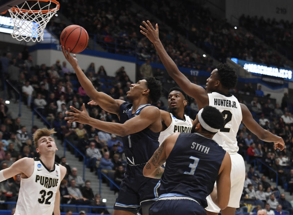 Old Dominion's Jason Wade goes up for a basket between the defense of Purdue's Aaron Wheeler and Eric Hunter Jr., right, during the first half of a first round men's college basketball game in the NCAA tournament, Thursday, March 21, 2019, in Hartford, Conn. (AP Photo/Jessica Hill)